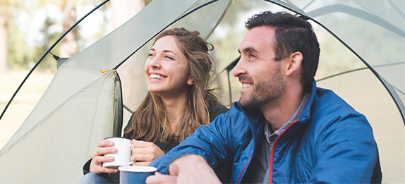 Man and woman camping Smiles Dental