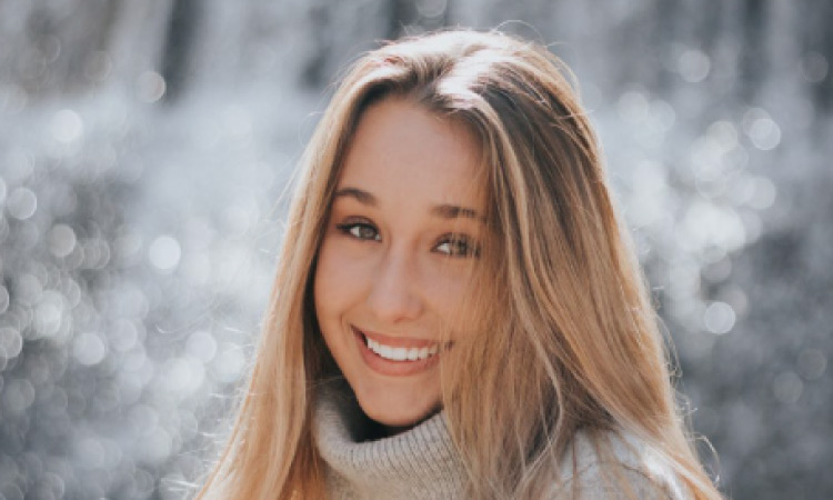 girl smiling in front of a waterfall