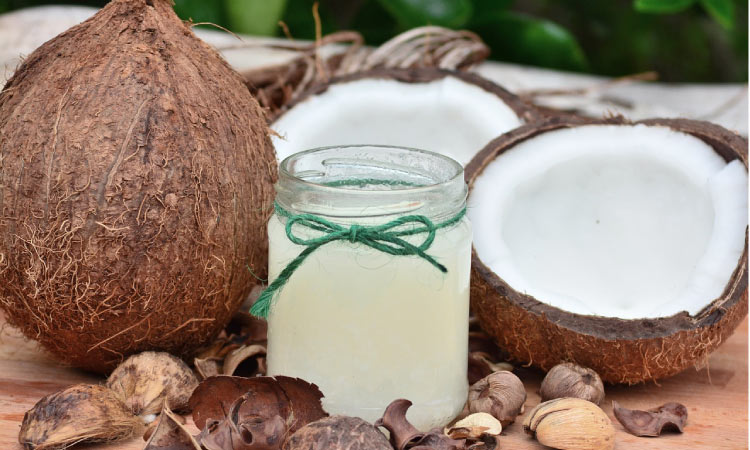coconuts on each side of a jar of coconut oil