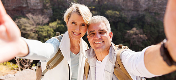Couple outside hiking and smiling