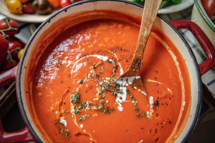 Aerial view of a pot of pureed tomato soup for after oral surgery